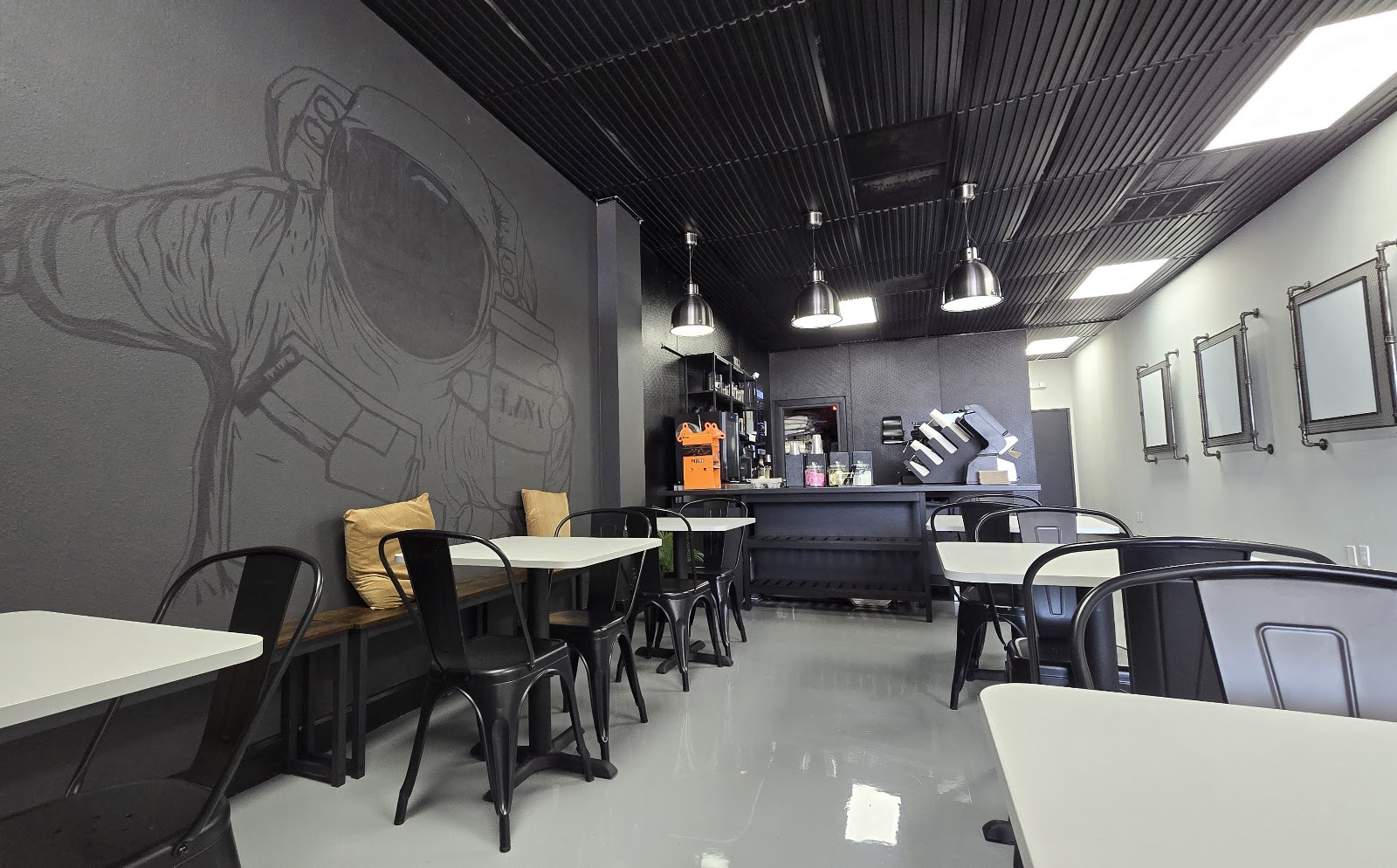 LVNA Cafe seating area with astronaut mural
